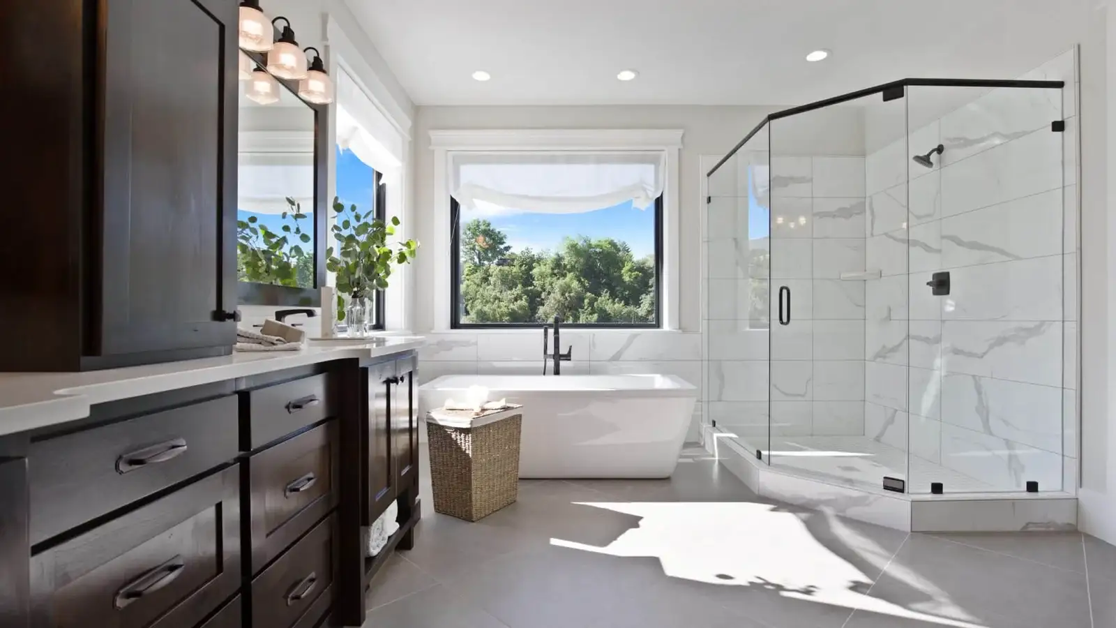Renovated primary bathroom with freestanding tub and glass shower
