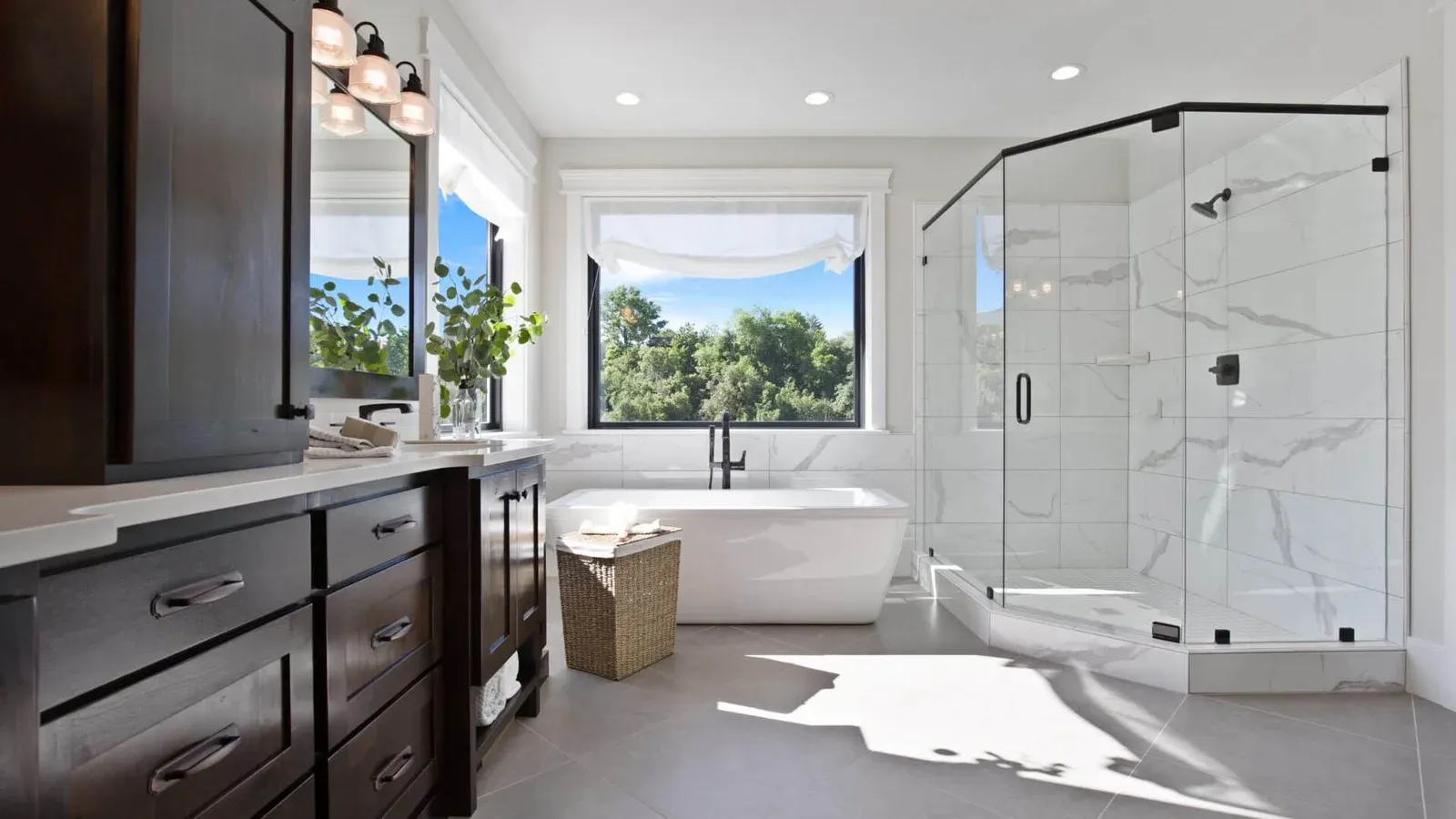 Renovated primary bathroom with freestanding tub and glass shower