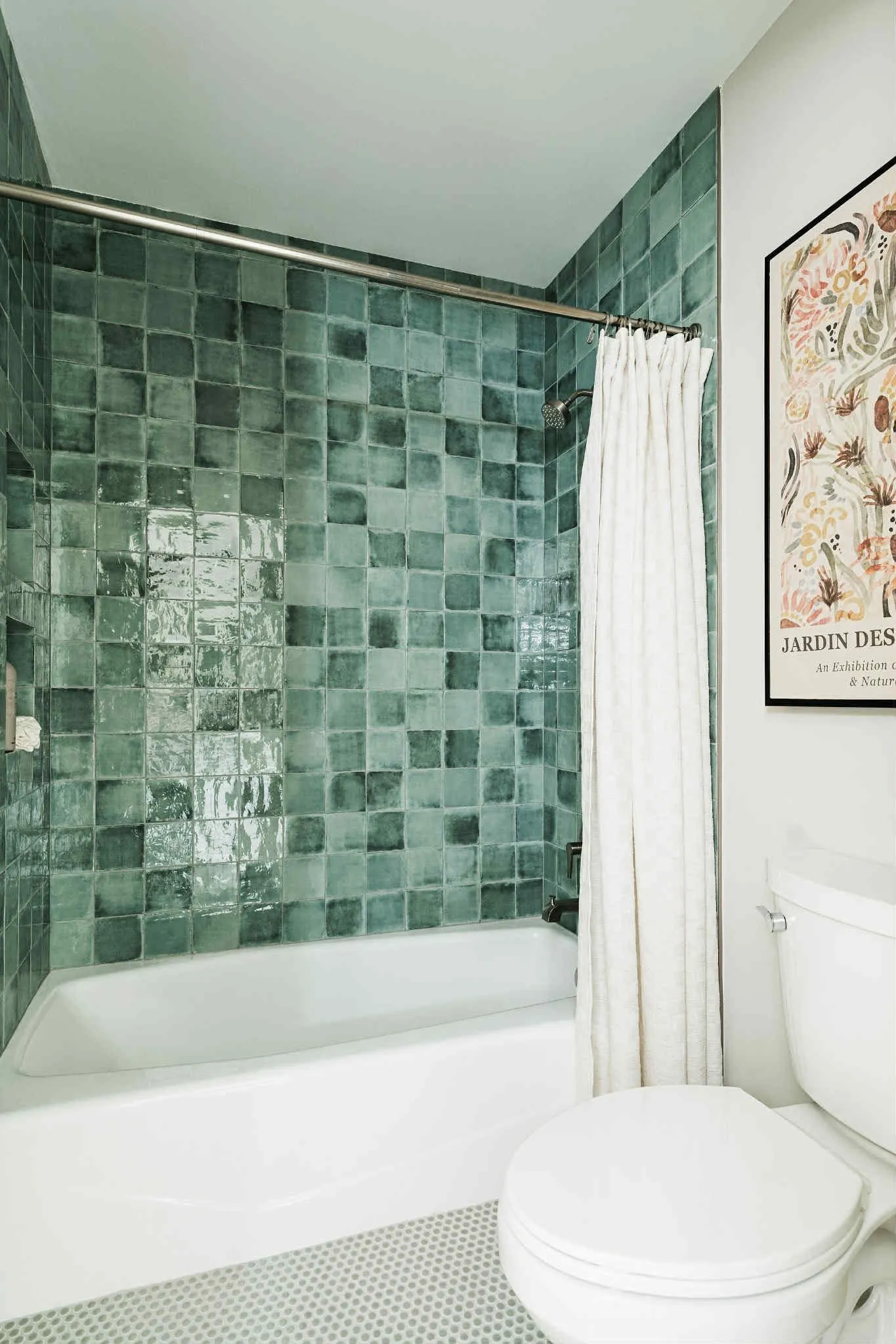 Bathtub remodel with glossy green square tile and white fixtures