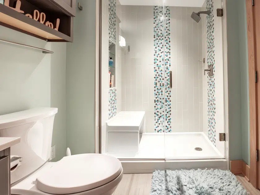 Walk-in shower with a built-in bench, glass enclosure, and low-threshold entry
