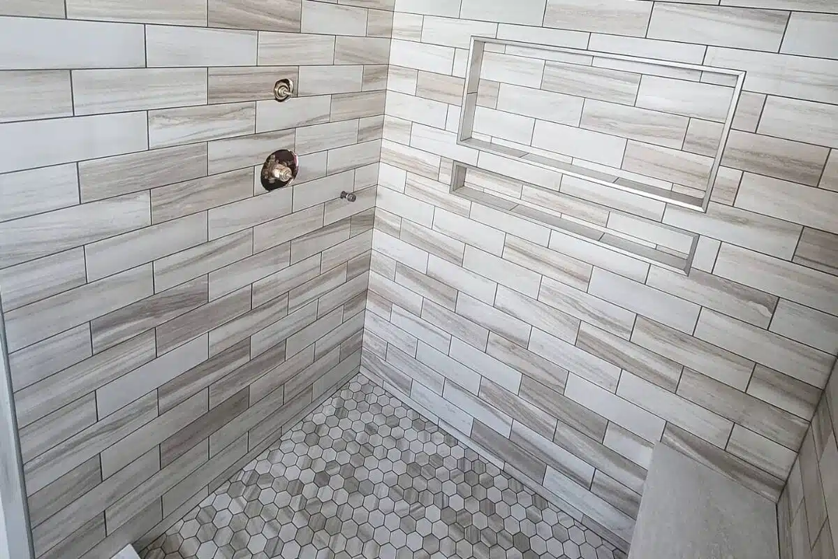 Cincinnati OH bathroom remodeling featuring a freshly tiled shower with natural colors.