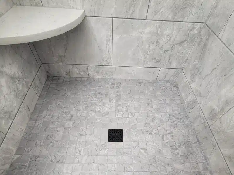 Tile installation in Cincinnati featuring a close-up of light gray shower tile.