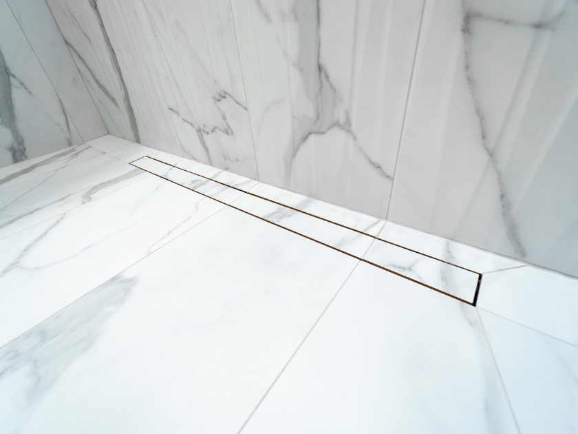 Close-up detail shot of drainage system and slip-resistant tile in curbless shower.